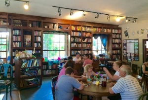 Enjoying book and food at Storieville. Photo Credit: M'Lissa Howen.